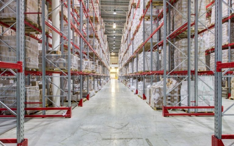 Spacious warehouse with organized shelving units.