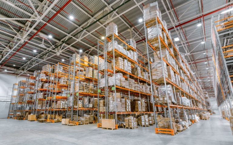 Large warehouse filled with stacked pallets