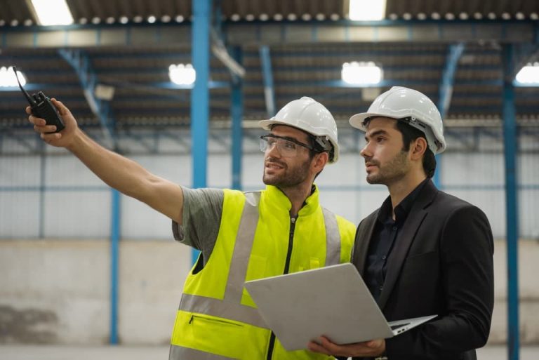 Two men discussing in warehouse