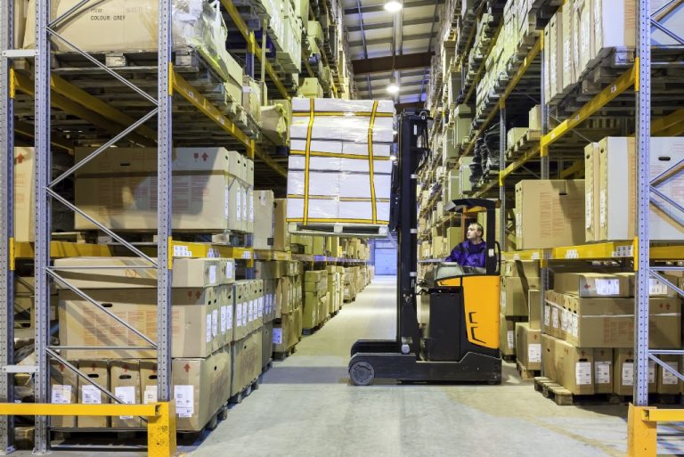Warehouse with stacked boxes and forklift