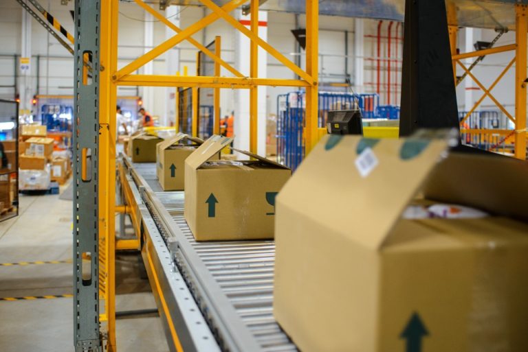 Conveyor belt with stacked cardboard boxes