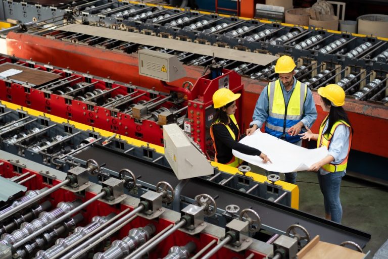 Workers discussing plans in factory