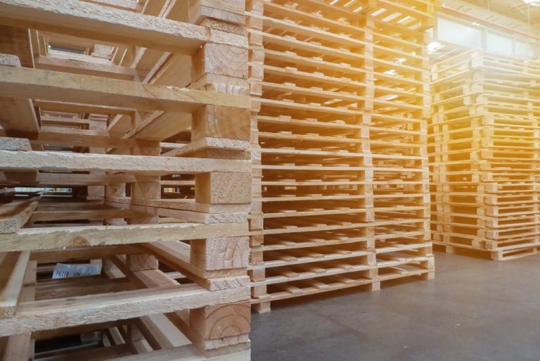 Stacked wooden pallets in warehouse