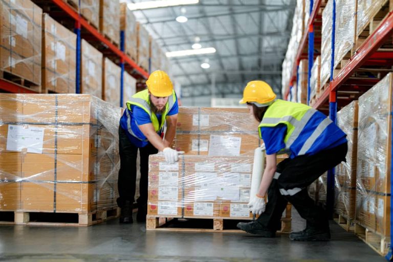 Workers handling boxes in warehouse